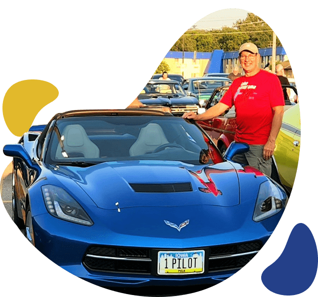 a man standing next to a blue luxury car