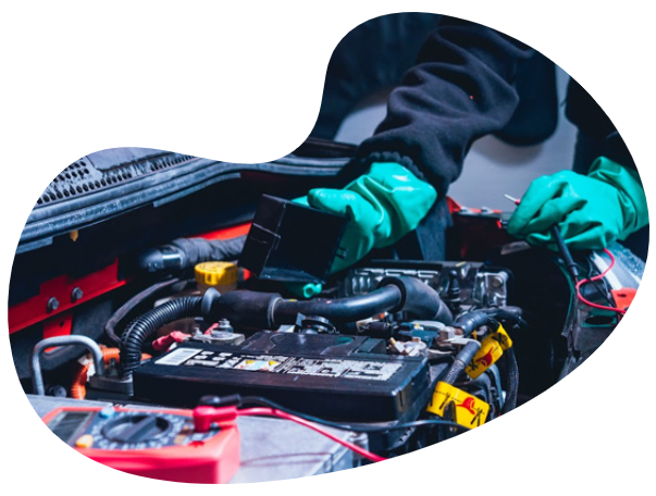 a man working on a car engine in a garage