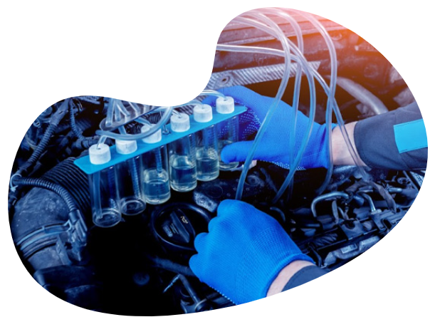 a man in blue gloves working on a car engine