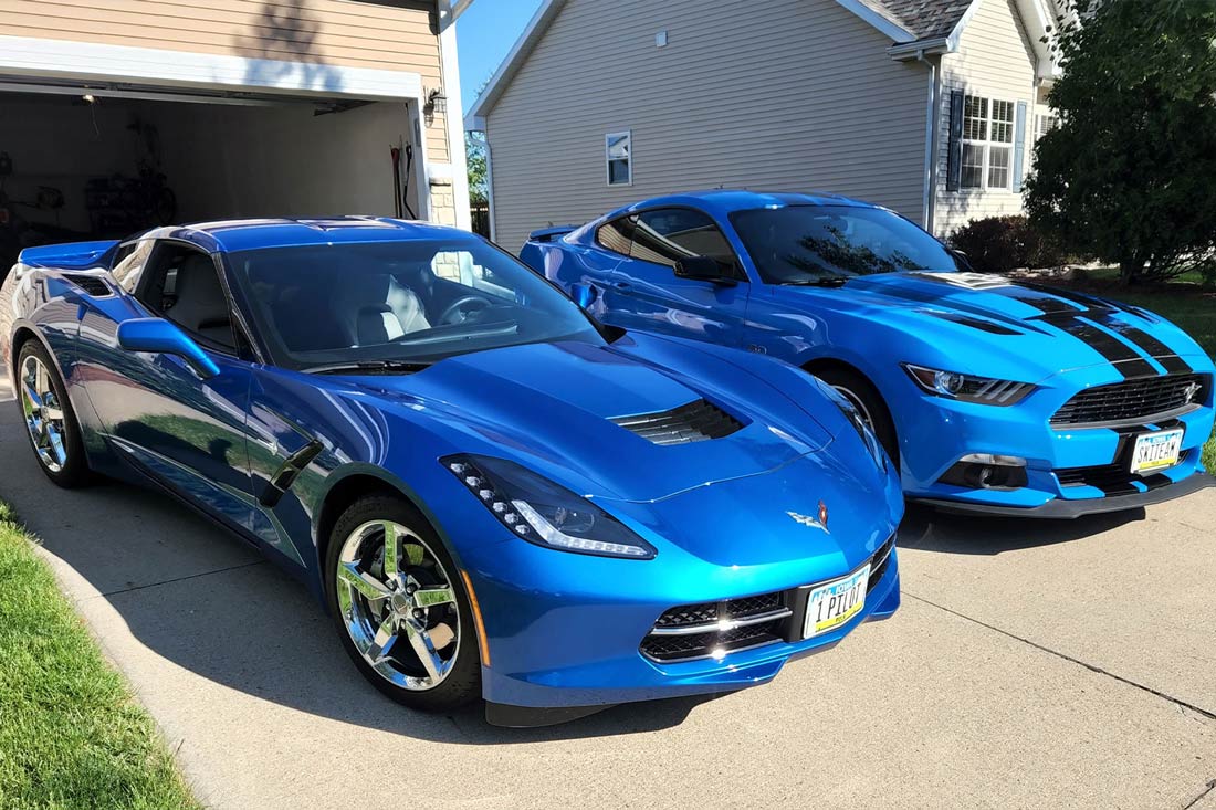 two blue sports car parked in a driveway
