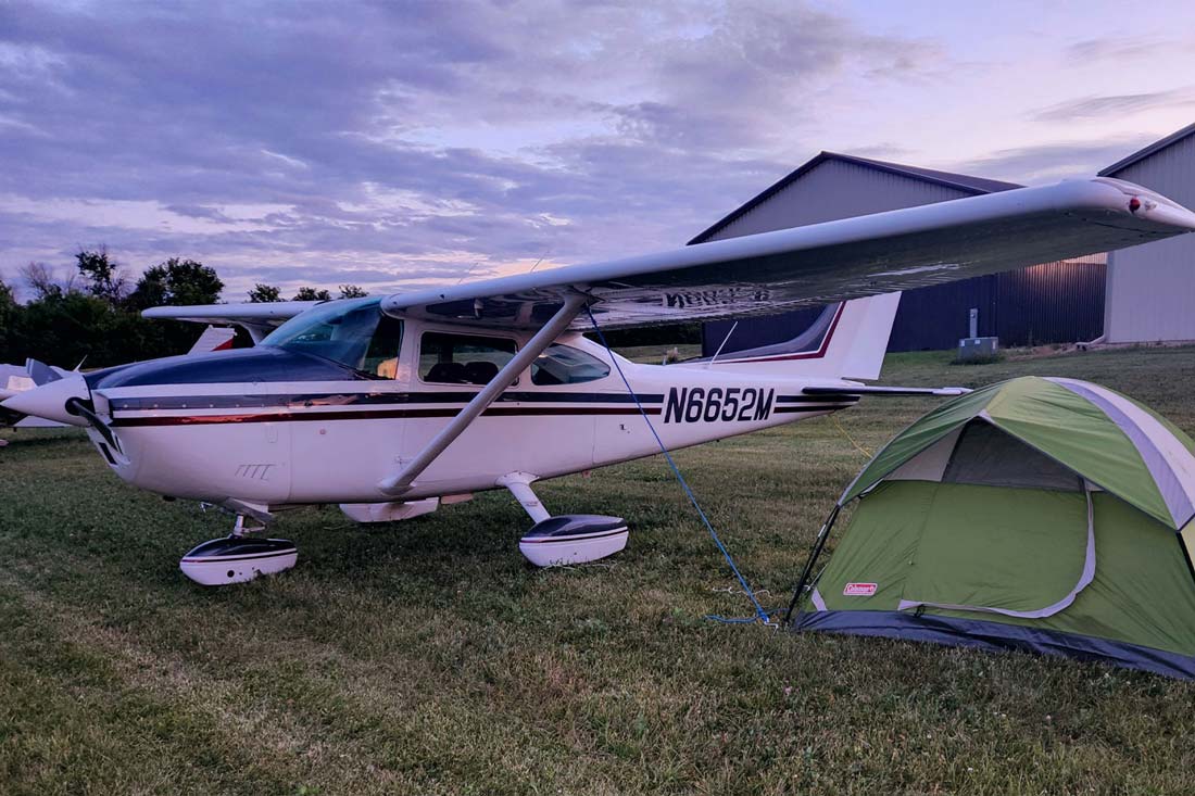 Jetplane besides a green tent