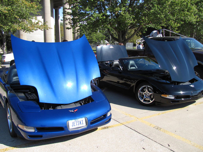 a opened hood two blue and black sports cars