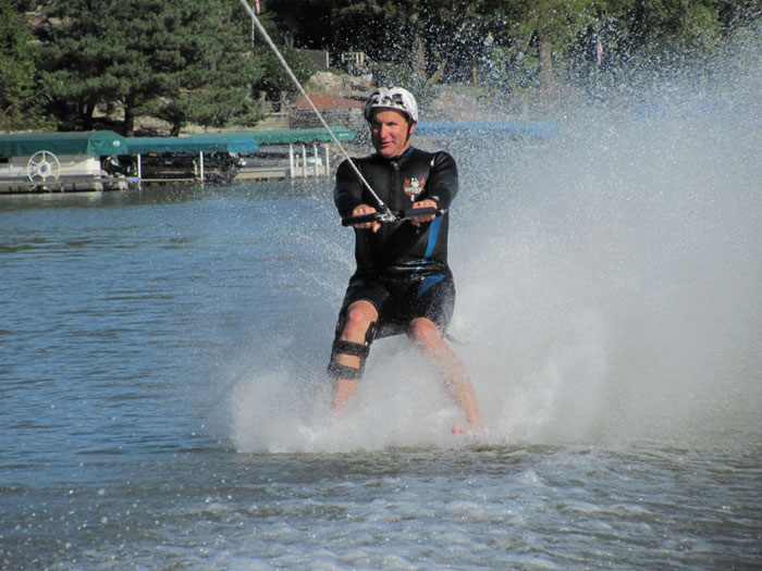a man riding water skis on top of a lake