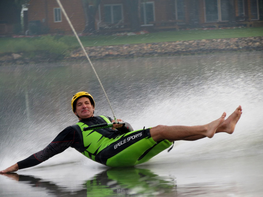 a man riding a wake board on top of a body of water
