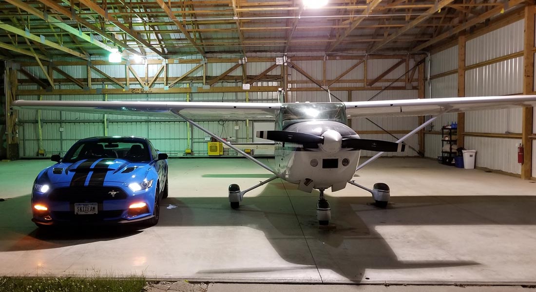 a blue mustang and a white airplane